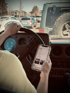 Young driver distracted by her phone while driving