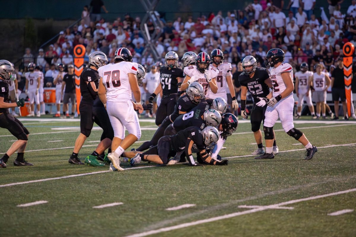 Storm and Cougar football players face off on Sept. 19. / Photo Credit: Wyatt Wilson
