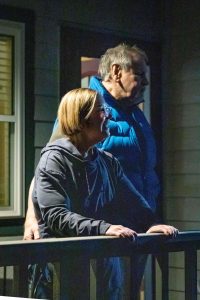 Jacot and her husband receiving a visit from the summit choirs in December 2024, listening to Christmas carols from their porch.